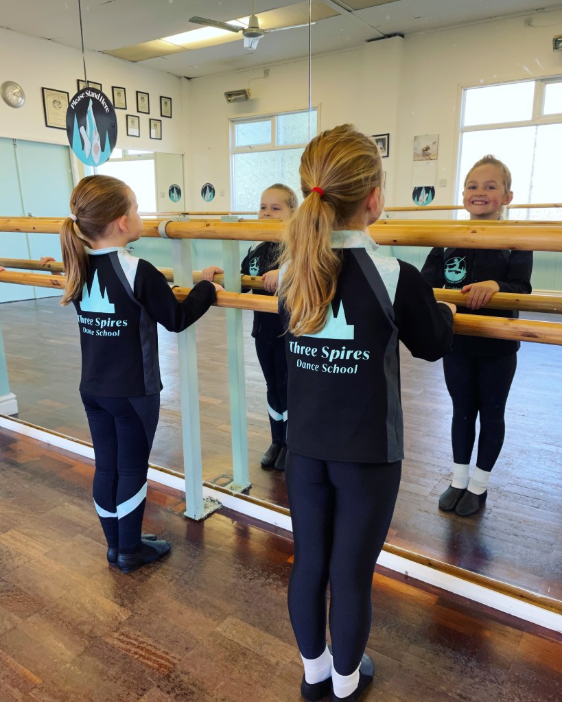 Children learning to dance at the barre
