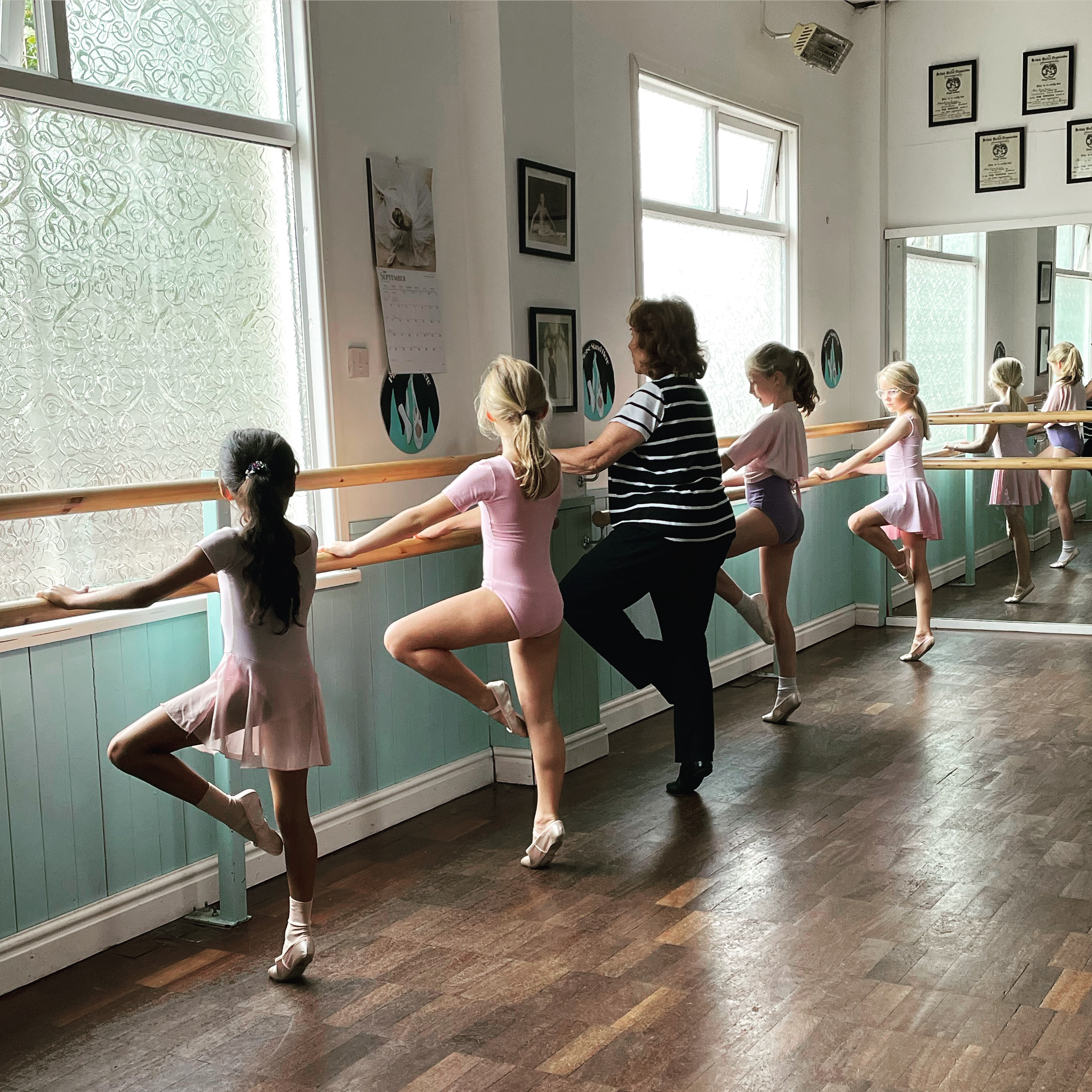 Students learning to dance at the barre